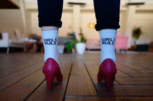 person wearing pair of white girls rule text printed socks