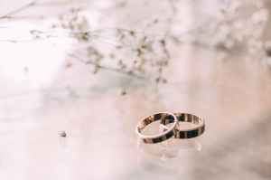 two silver colored rings on beige surface